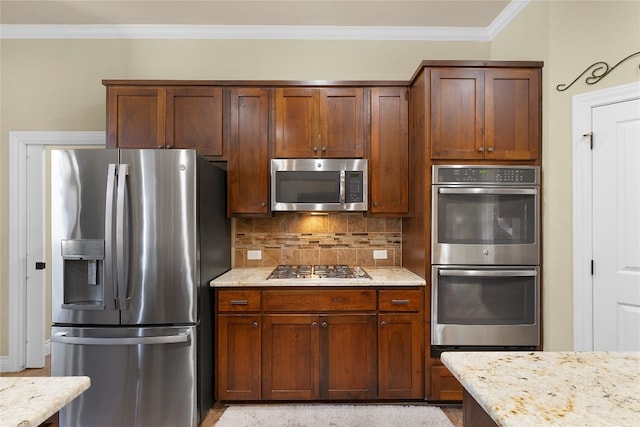 kitchen with decorative backsplash, light stone counters, crown molding, and appliances with stainless steel finishes