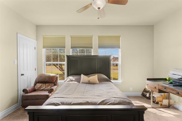 bedroom with ceiling fan and light tile patterned floors