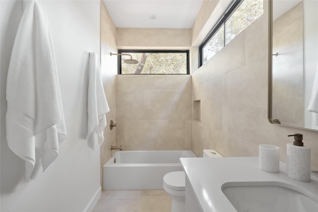 full bathroom with toilet, vanity, tile patterned floors, and tiled shower / bath combo