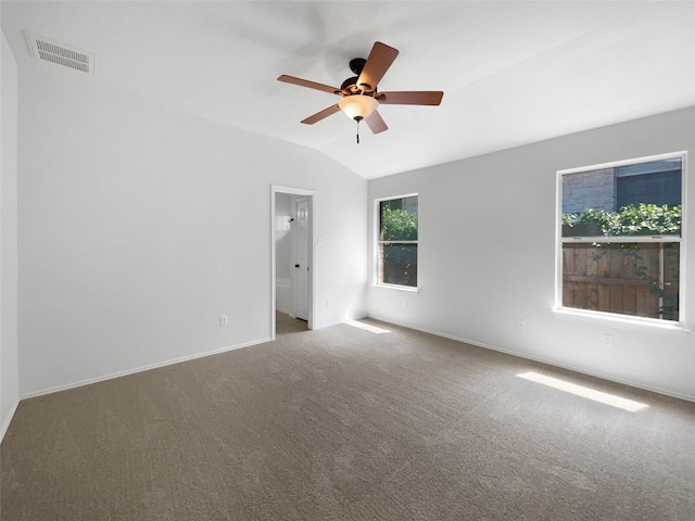 carpeted empty room with vaulted ceiling and ceiling fan