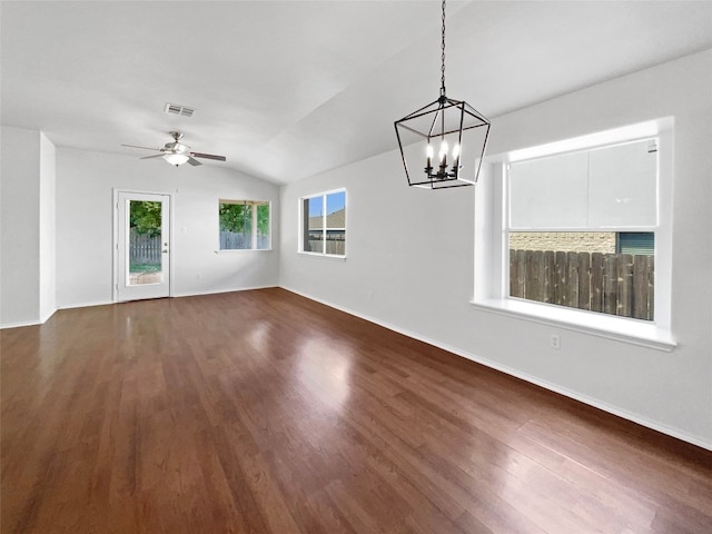 interior space with ceiling fan with notable chandelier, vaulted ceiling, and dark wood-type flooring