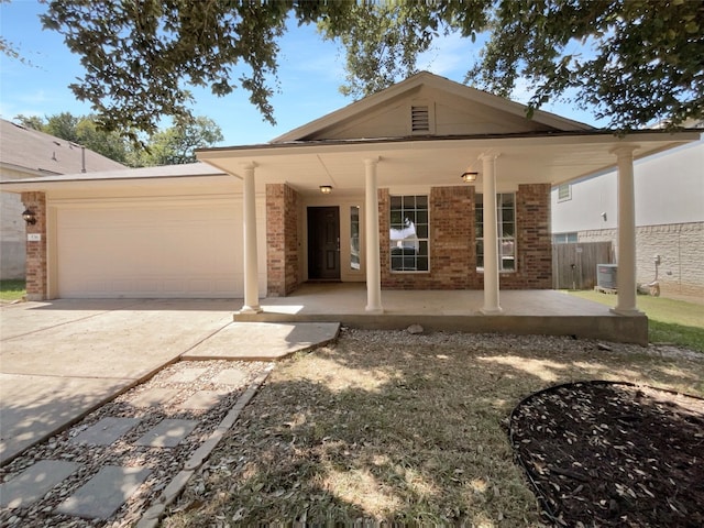 view of front of house with a garage and central air condition unit