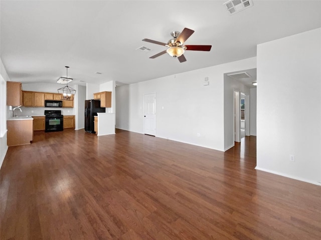 unfurnished living room with ceiling fan, dark hardwood / wood-style floors, and sink