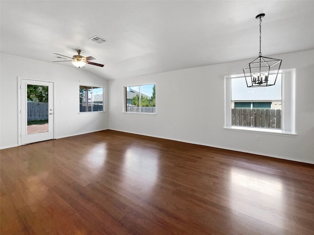 unfurnished living room with ceiling fan with notable chandelier, vaulted ceiling, and dark hardwood / wood-style flooring