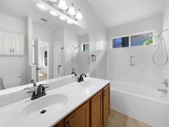 full bathroom with vanity, lofted ceiling, toilet,  shower combination, and tile patterned floors