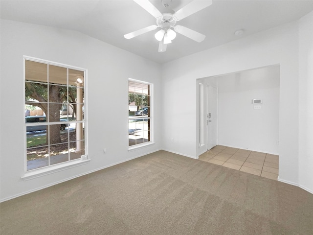 spare room featuring ceiling fan and light colored carpet