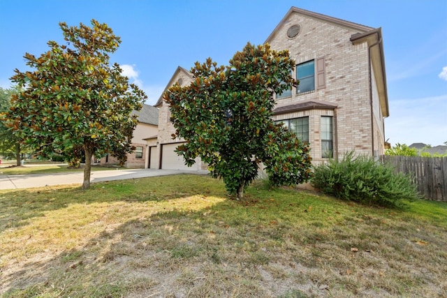 view of front of house with a garage and a front lawn