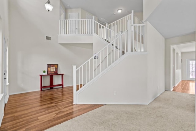 interior space featuring carpet floors and a high ceiling