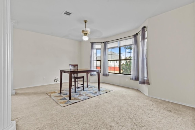 home office with ceiling fan and light carpet