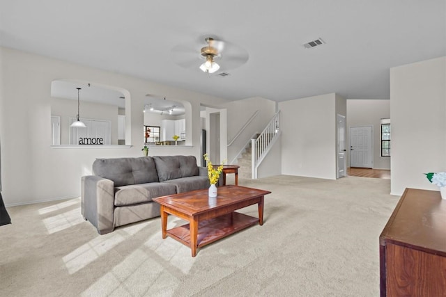 carpeted living room featuring ceiling fan