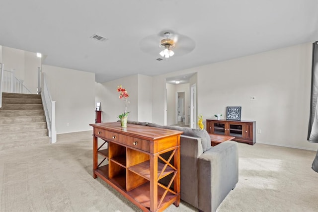 living room featuring light carpet and ceiling fan