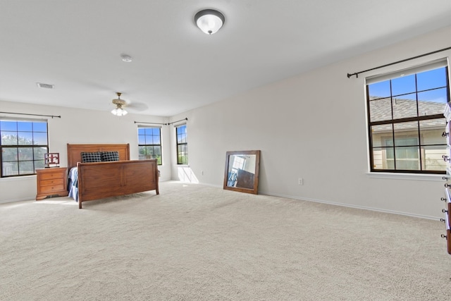 bedroom with light colored carpet and ceiling fan