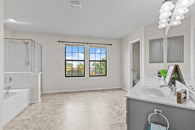 full bathroom with vanity, shower with separate bathtub, and toilet