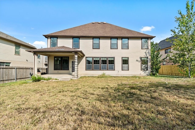 back of property featuring a lawn and a patio area