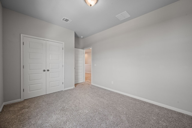 unfurnished bedroom featuring carpet floors and a closet