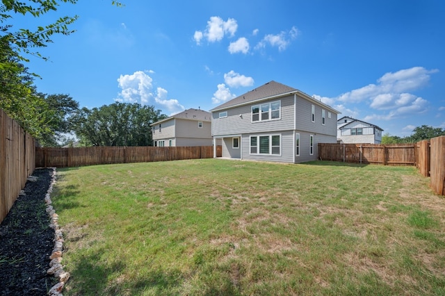 rear view of house with a lawn