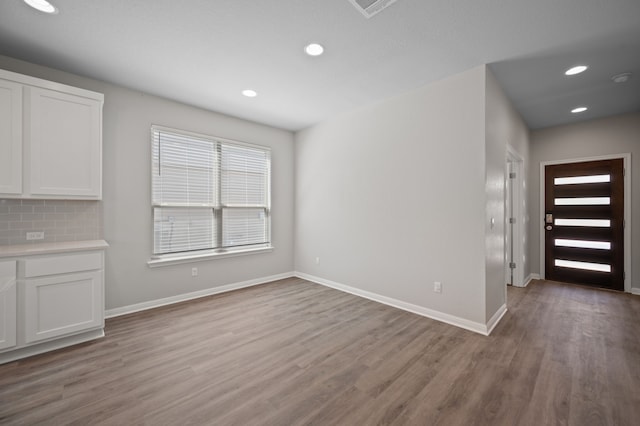 unfurnished dining area featuring light wood-type flooring