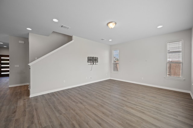 unfurnished living room featuring dark wood-type flooring