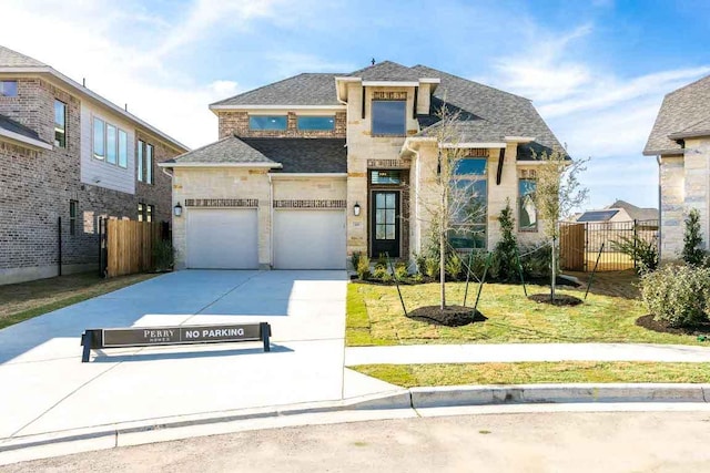 view of front of property featuring a garage, driveway, a shingled roof, fence, and a front lawn