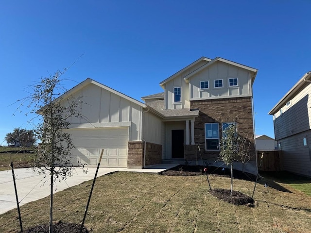 view of front of home featuring a garage and a front yard