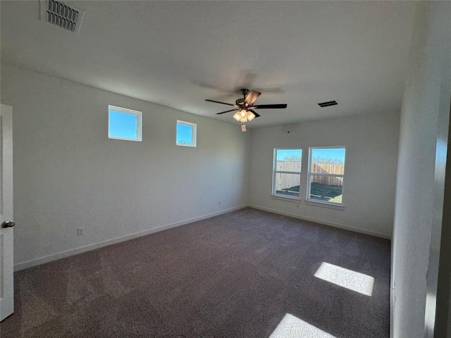 carpeted spare room with ceiling fan