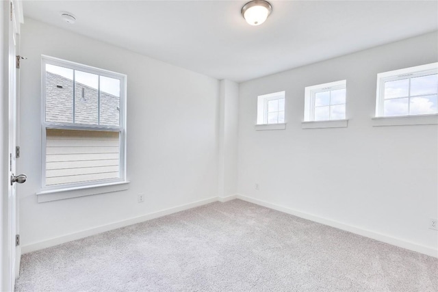 empty room with carpet flooring and baseboards