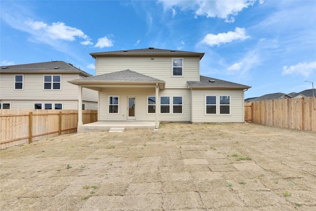 back of property with a patio and a fenced backyard