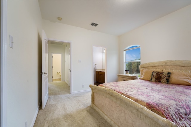 carpeted bedroom featuring ensuite bathroom