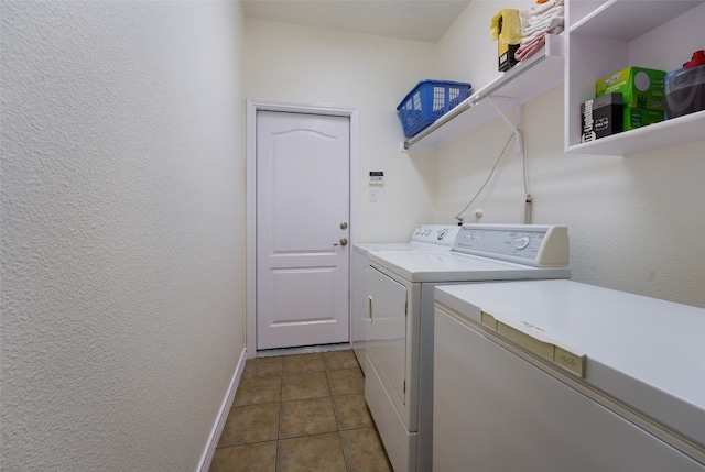 washroom featuring washing machine and clothes dryer and tile patterned floors