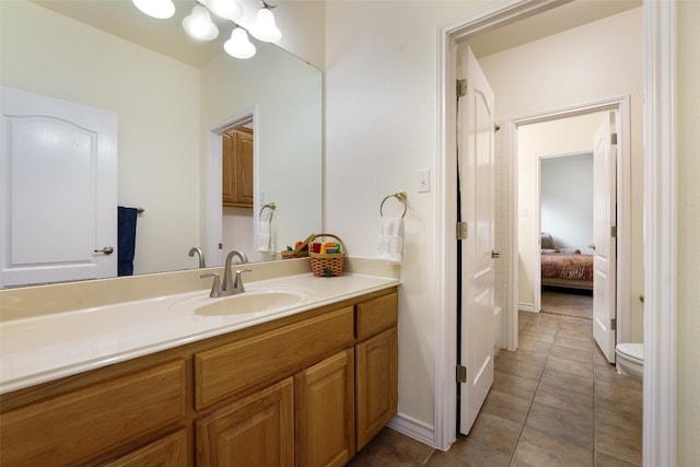 bathroom featuring vanity, toilet, and tile patterned floors