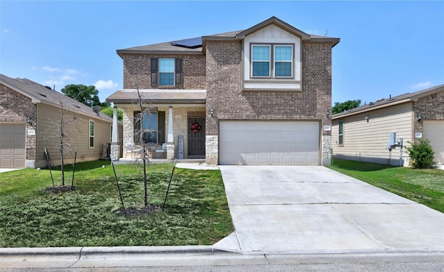 view of front of house featuring a garage, a front yard, and covered porch