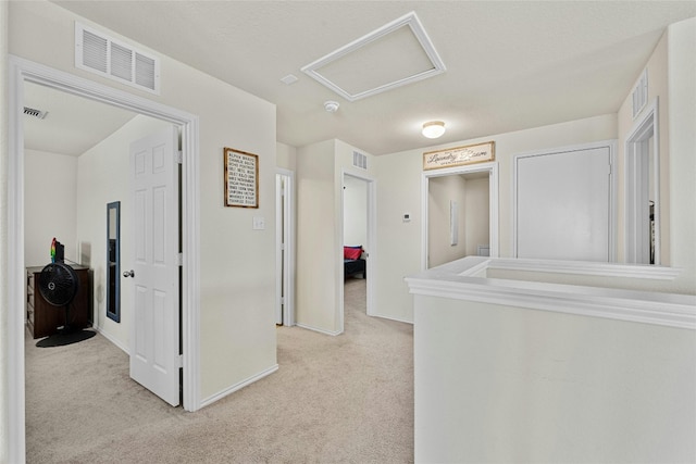 hallway featuring light colored carpet