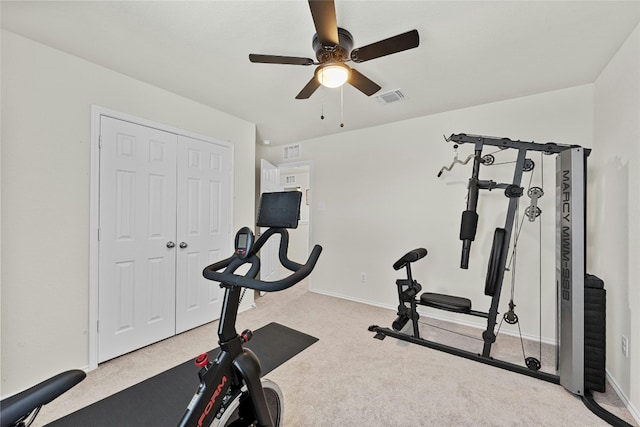 exercise area featuring ceiling fan and light colored carpet