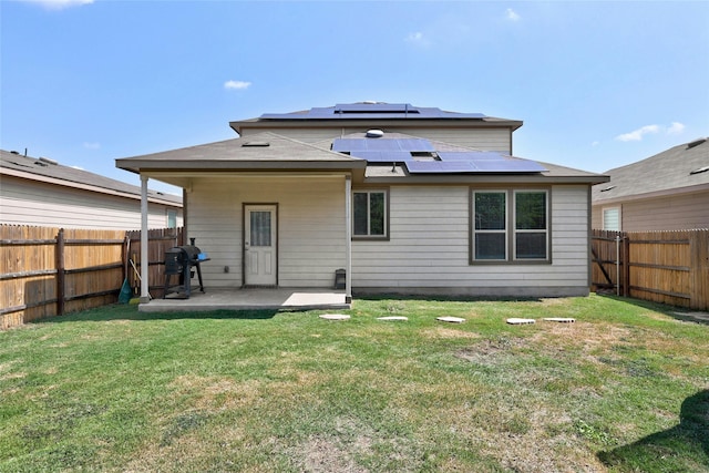 back of house featuring a yard and a patio