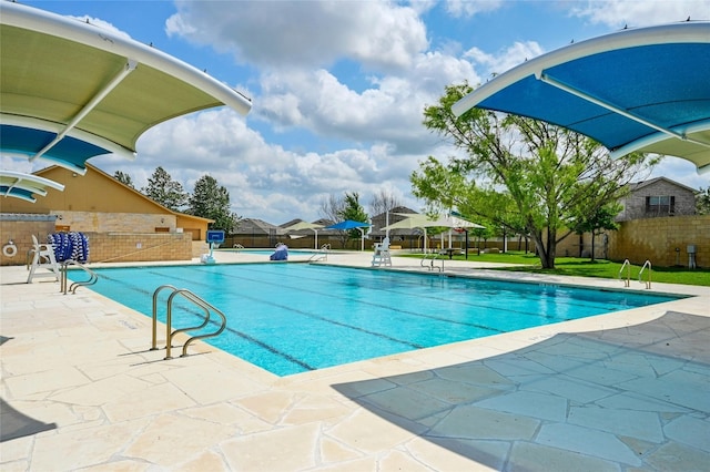 view of swimming pool featuring a patio area