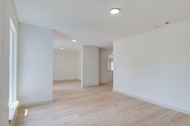 unfurnished room with light wood-type flooring