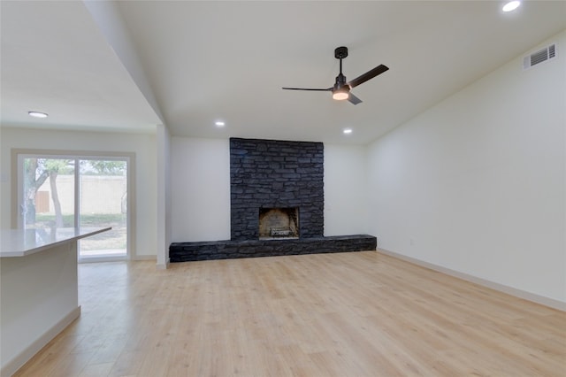 unfurnished living room featuring light hardwood / wood-style floors, a fireplace, and ceiling fan