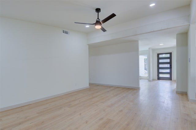 spare room with light wood-type flooring and ceiling fan