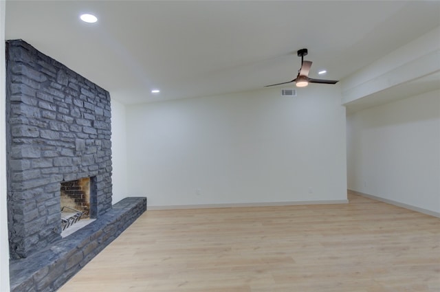 unfurnished living room featuring light hardwood / wood-style floors, a fireplace, and ceiling fan