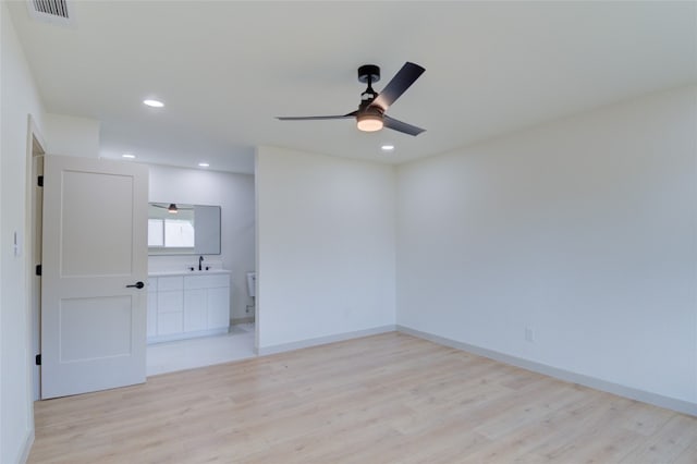 spare room featuring light wood-type flooring and ceiling fan