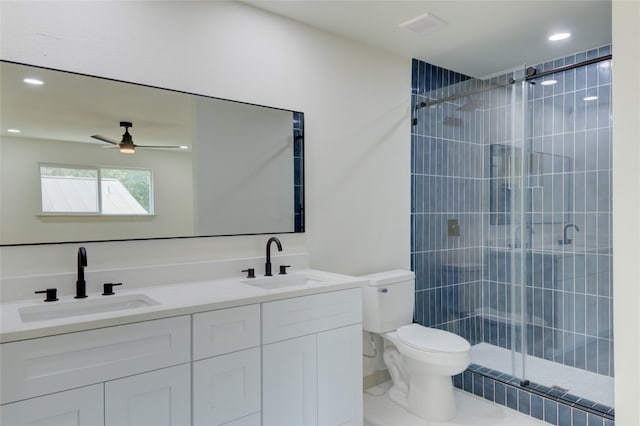 bathroom with ceiling fan, walk in shower, vanity, and toilet