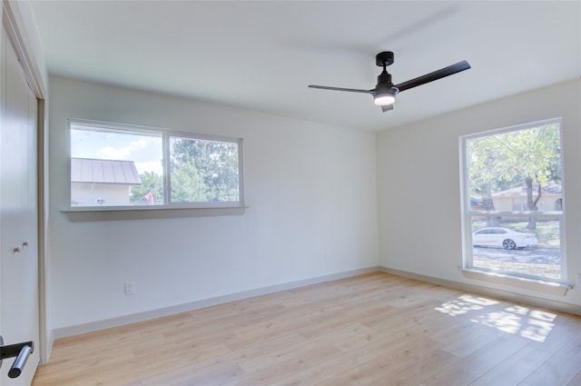 unfurnished room featuring light hardwood / wood-style flooring, ceiling fan, and a healthy amount of sunlight