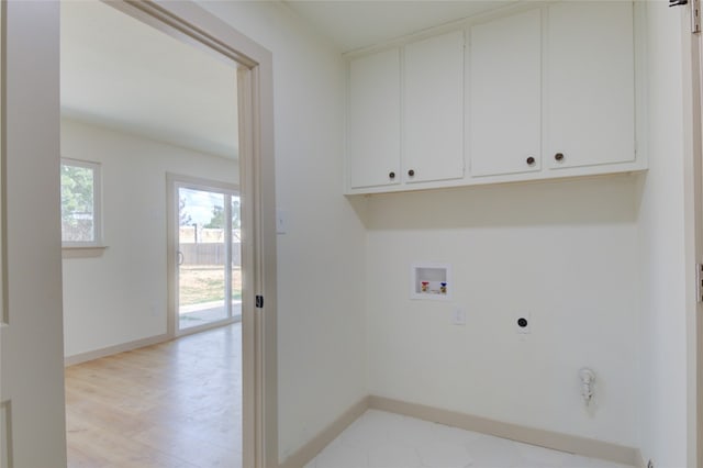 laundry room with washer hookup, cabinets, light hardwood / wood-style flooring, and electric dryer hookup