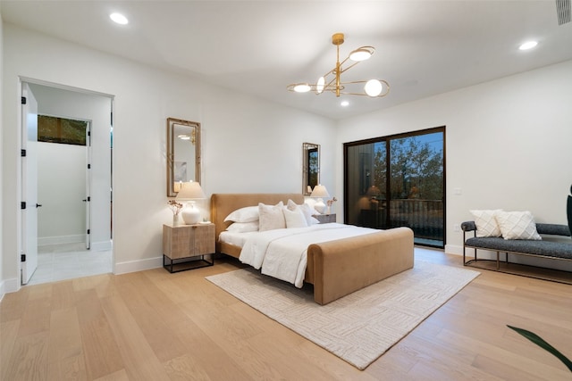 bedroom with light hardwood / wood-style floors, access to outside, and an inviting chandelier