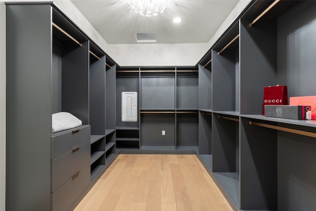 walk in closet with light hardwood / wood-style flooring