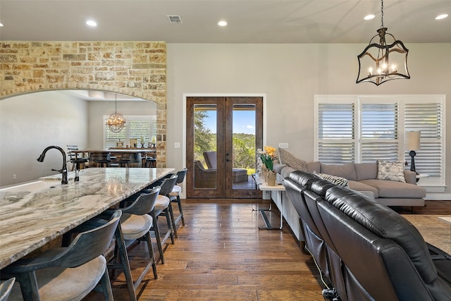 interior space featuring an inviting chandelier, dark wood-type flooring, sink, and french doors