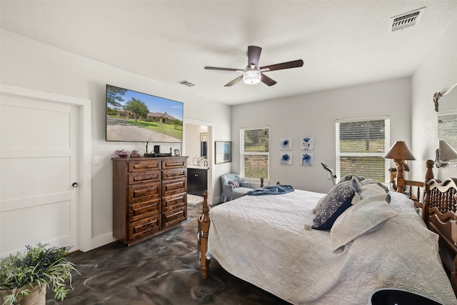 bedroom with ensuite bath, ceiling fan, and a textured ceiling