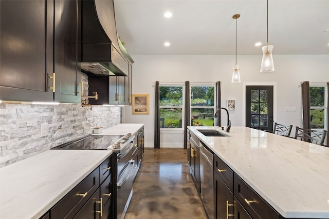 kitchen with light stone counters, tasteful backsplash, sink, wall chimney exhaust hood, and appliances with stainless steel finishes