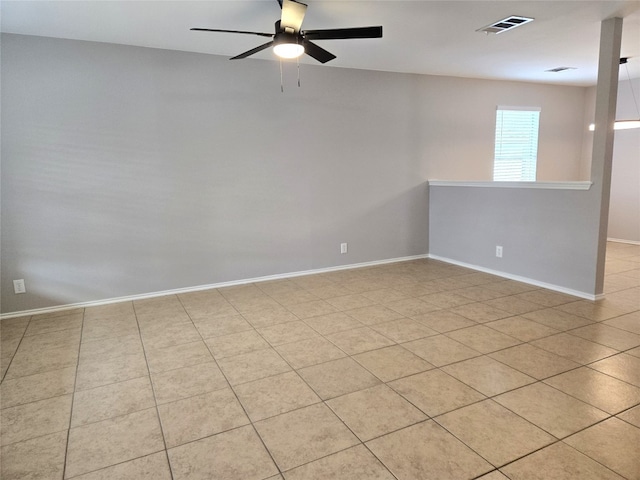 spare room featuring ceiling fan and light tile patterned floors