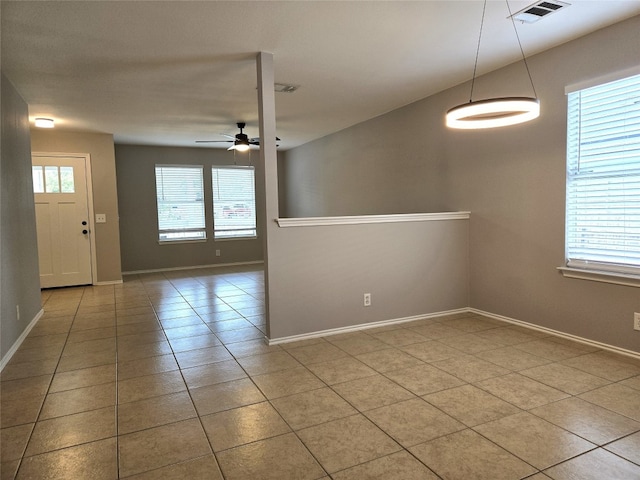 unfurnished room with light tile patterned flooring and ceiling fan